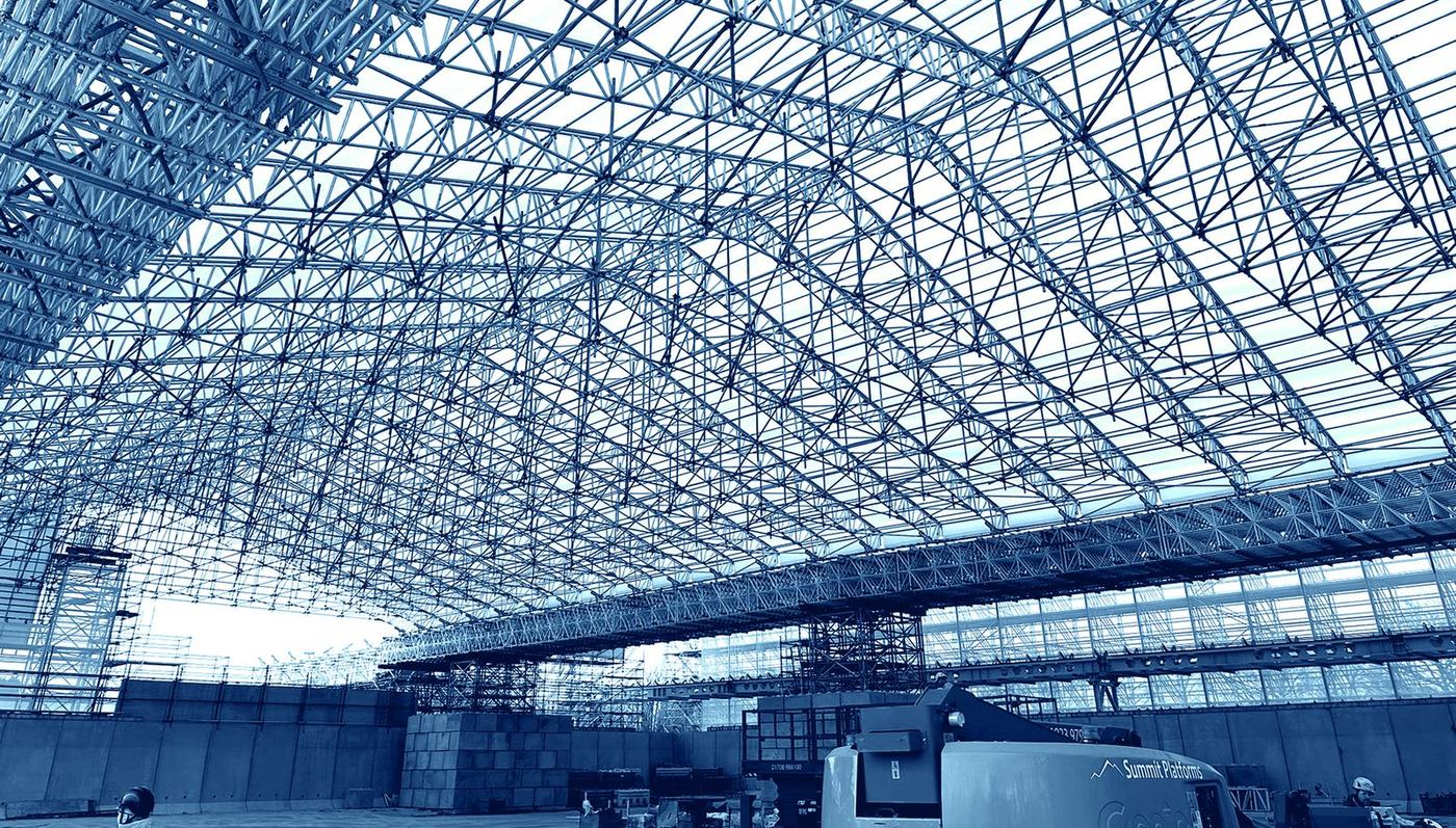 Interior view of a large-span Scafom-rux VECTA temporary roof over a live working area